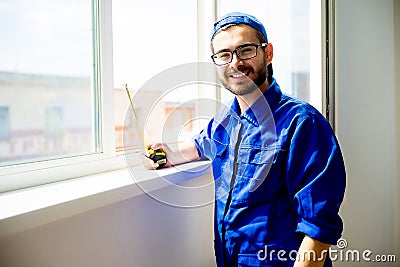 Construction worker installing window Stock Photo