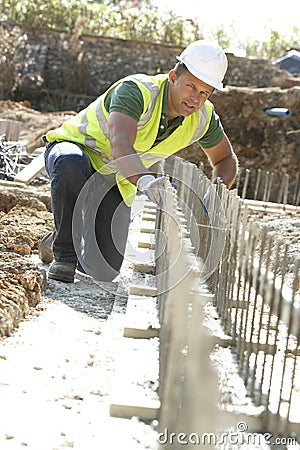 Construction Worker Laying Foundations Stock Photo