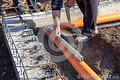 Construction Worker Laying Installing Sewer Pipes Stock Photo