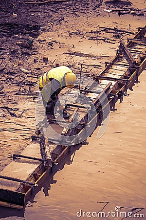 Construction worker leveling concrete formwork Editorial Stock Photo