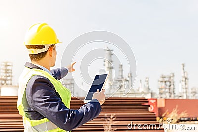 Construction Worker Planning Contractor Checking at site gas, oil, energy and factory construction. A man hold tablet for working Stock Photo