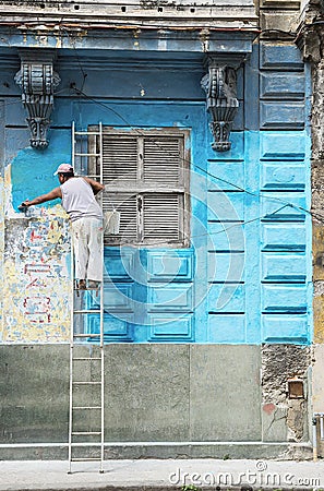 Construction worker renovates facade of old colonial building in Havana Vieja, Cuba Editorial Stock Photo
