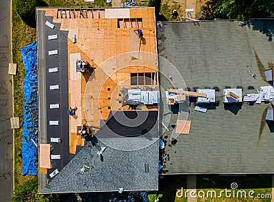 Construction worker on renovation roof the house installed new shingles Editorial Stock Photo