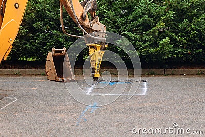 Construction worker repairing road with Jackhammer Stock Photo