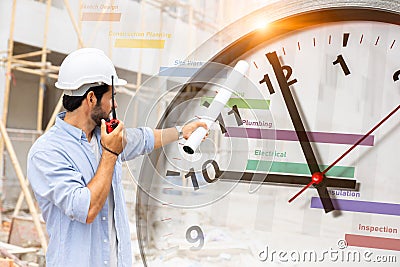 Construction worker with schedule project timeline and working time clock for control timing punctual building process concept Stock Photo