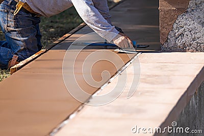 Construction Worker Smoothing Wet Cement With Hand Edger Tool Stock Photo