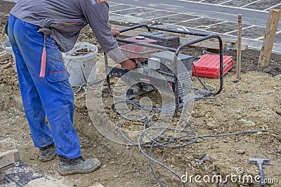 Construction Worker starts the portable Electric Generator 2 Stock Photo