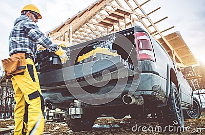 Construction Worker Taking Tools Boxes From His Pickup Truck Stock Photo