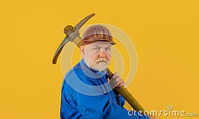 Construction worker in uniform with pickaxe. Miner man with pickaxe. Mining industry. Male laborer with building tools Stock Photo
