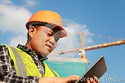 Construction worker using digital tablet Stock Photo