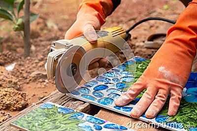 Construction worker wearing orange rubber gloves Stock Photo