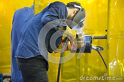 The construction worker welding the steel tube. Editorial Stock Photo