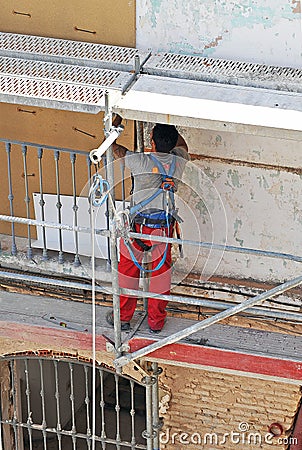 Construction worker working on the rehabilitation of an old house Editorial Stock Photo