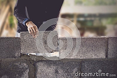 Construction workers are building cement walls with brick blocks Stock Photo