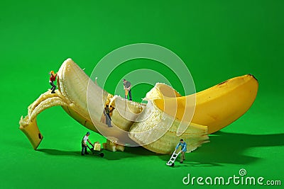 Construction Workers in Conceptual Food Imagery With Banana Stock Photo