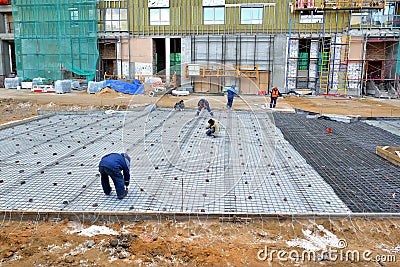 Construction workers doind on a iron reinforcement and concrete Editorial Stock Photo