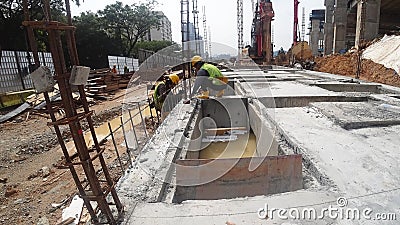 Construction workers fabricating steel reinforcement bar at the construction site. Editorial Stock Photo