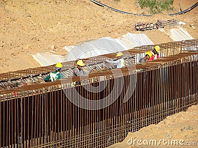 Construction workers fabricating steel reinforcement bar at the construction site. Editorial Stock Photo