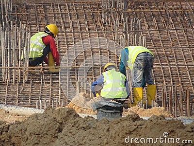 Construction workers fabricating steel reinforcement bar at the construction site. Editorial Stock Photo