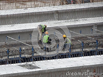 Construction workers fabricating steel reinforcement bar at the construction site. Editorial Stock Photo