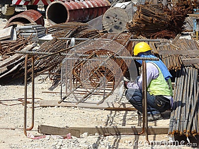 Construction workers fabricating steel reinforcement bar at the construction site. Editorial Stock Photo