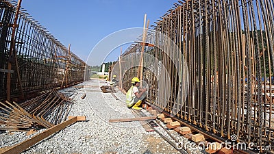 Construction workers fabricating steel reinforcement bar at the construction site. Editorial Stock Photo