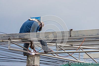 A construction workers installing beam formwork. Formwork is located at the high level Stock Photo