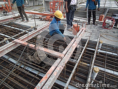 Construction workers are installing steel rods in reinforced concrete post tension site concrete steel Editorial Stock Photo