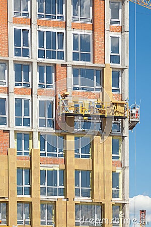 Construction workers insulating house facade with mineral rock wool installation. Stock Photo