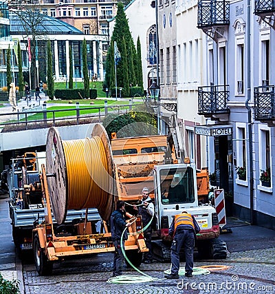 Construction workers make repair urban engineering. Replacement of cable laying modern optical communication Editorial Stock Photo