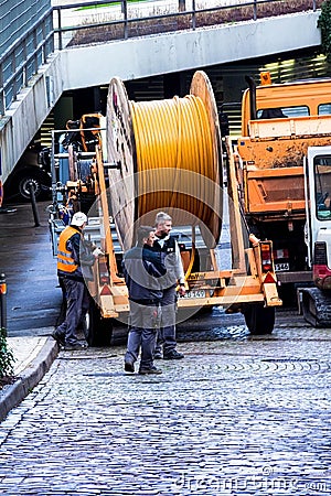 Construction workers make repair urban engineering. Replacement of cable laying modern optical communication Editorial Stock Photo