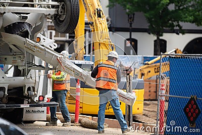 Construction workers pouring concrete Editorial Stock Photo