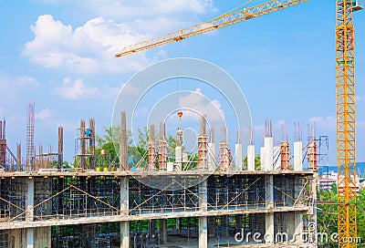 Construction workers site and building of housing at laborer work outdoor which has tower crane blue sky background with copy sp Stock Photo