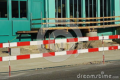 Construction equipment and material, mostly pipes, for civil engineering construction site bordered by barrier planks Stock Photo