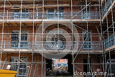Construction works in progress at new residential multistorey apartment building made of brick and concrete block Stock Photo