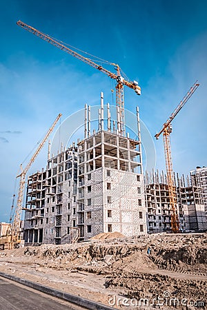 Constructionsite and construction cranes Stock Photo