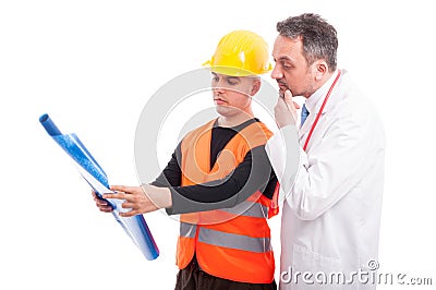 Constructor showing blue prints to doctor Stock Photo