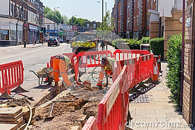 Constuction wokers back to work, laying fibre optic cable Editorial Stock Photo