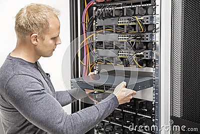 IT consultant build network racks in datacenter Stock Photo