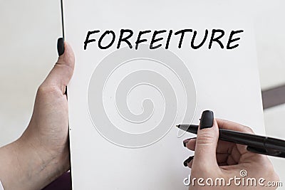 Consulting text message FORFEITURE written by a girl on a piece of paper Stock Photo
