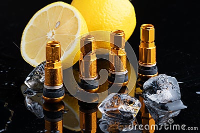 Consumables for tire repair, new gold nipples for car tires and a yellow lemon, Metal tire valve , ice cube, Clamp-in Tubeless Stock Photo