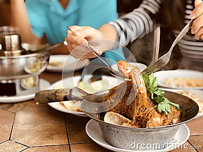 consumer eating shrimp potted with vermicelli Stock Photo