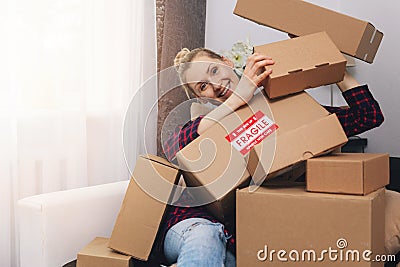 Consumerism concept - happy woman with cardboard boxes at home after shopping Stock Photo