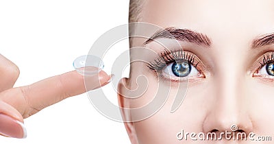 Contact lens on index finger near beautiful female face. Stock Photo