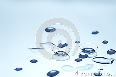 Contact lenses with water drops on reflective surface Stock Photo