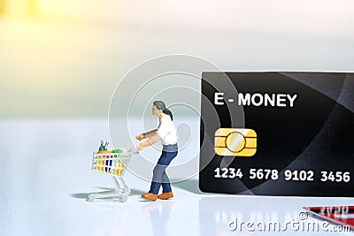 Contact-less payment. A men going shop and pay using electronic money e-money. Miniature people figurines toys conceptual Stock Photo