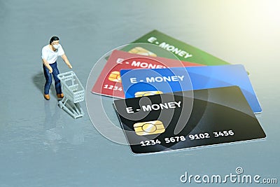 Contact-less payment. Women going shop and pay using electronic money e-money. Miniature people figurines toys conceptual Stock Photo