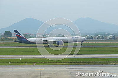 Contact point. The Russian Boeing 777-3M0 VP-BGC of the Aeroflot company makes landing at the airport of Noybay. Hanoi, Vietnam Editorial Stock Photo