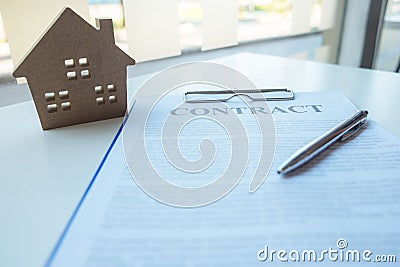 Contacting the buying or selling of real estate through a sales representative offering a contract to buy a house or apartment, Stock Photo