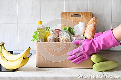 Contactless delivery food. Box with stocks for rainy day Stock Photo